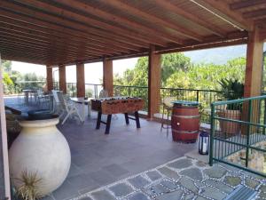 a patio with a table and a large vase at La Cabana Cinque Terre Monterosso in Monterosso al Mare