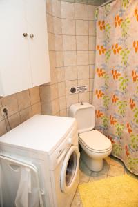 a bathroom with a toilet and a shower curtain at HOUSE WITH GARDEN Netflix in Néa Kerasiá