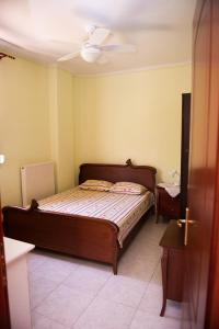 a bedroom with a bed and a ceiling fan at HOUSE WITH GARDEN Netflix in Néa Kerasiá +3 photos