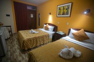 Postel nebo postele na pokoji v ubytování Hotel Suite Plaza