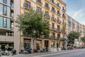 a group of motorcycles parked in front of a building at Bcn Paseo De Gracia Rocamora Apartment in Barcelona