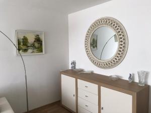 a bathroom with a mirror on the wall at Jura Apartaments in Palanga +16 photos