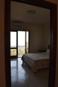 a bedroom with a bed and a view of a balcony at Villa Di Martino in Vico Equense