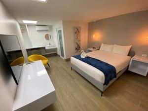 a hotel room with a bed and a desk and a room at Marina de Salinas in Salinas