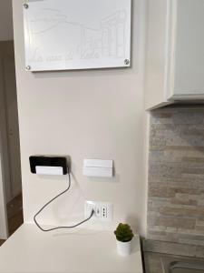 a kitchen with a phone plugged into a wall at La casa di Vesta in Pompei