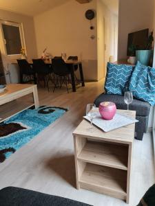 a living room with a couch and a table with wine glasses at Holidays in Dirkshorn (Park de Horn 613) in Dirkshorn