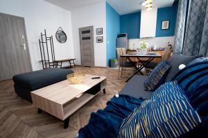 a living room with a couch and a table at Apartament INSIDE - centrum Bielsko-Biała in Bielsko-Biała