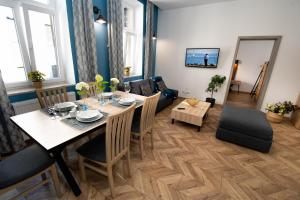 a dining room with a table and a couch at Apartament INSIDE - centrum Bielsko-Biała in Bielsko-Biala
