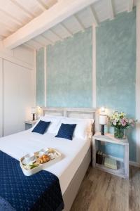 a bedroom with a bed with a tray of food on it at Terrace apt in Piazza Strozzi-center of Florence in Florence