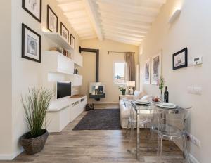 a living room with a table and a couch and a television at Terrace apt in Piazza Strozzi-center of Florence in Florence