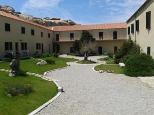 a courtyard of a building with a walkway at La Maddalena Apartment in La Maddalena