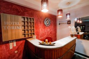 a bar in a hotel with red walls and lights at Hotel Torini in Parga