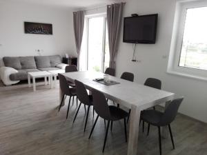 a living room with a white table and chairs at apartmán U Rané BOBULE in Znojmo