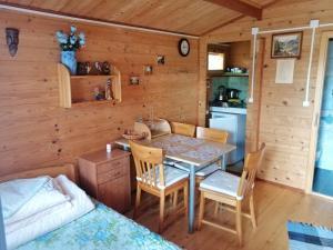 a dining room with a table and chairs in a cabin at Eko-Wakacje in Polańczyk