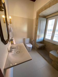 a bathroom with a sink and a toilet at Solar De Alarcao in Guarda