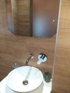 a bathroom with a white sink and a mirror at Sunrise Studio in Skala Kallirachis