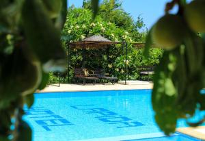 een zwembad met een tafel en een parasol bij Lapida Garden in Kyrenia