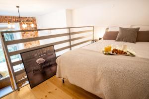 a bedroom with a bed with a plate of food on it at Tower Street Apartments in Krakow