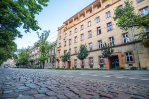 a cobblestone street in front of a large building at Tower Street Apartments in Krakow