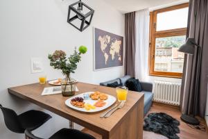 a dining room table with a plate of food on it at Modern and Bright Apartments - Main Street in Sarajevo