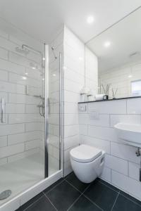 uma casa de banho com um chuveiro, um WC e um lavatório. em Libarty Hotels em Weinstadt