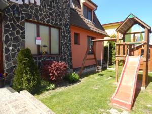 a house with a slide in front of it at RUBIN in Veľký Meder