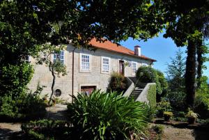 an old stone house with a staircase in front of it at Casa de Cerqueda in Celorico de Basto