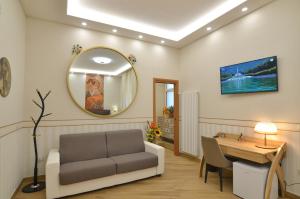 a living room with a couch and a table and a mirror at CASERTA DELUXE BIS in Caserta