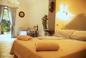 a bedroom with two beds and a clock on the wall at B&B del Giglio in Cefalù