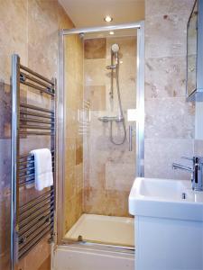a bathroom with a shower and a sink at Marina living with parking, balcony, quiet and secure in Brighton & Hove
