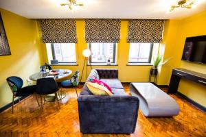 a living room with a couch and a table at LS1 - Luxury City Centre Apartments Leeds in Leeds +246 photos