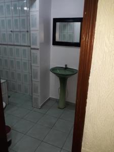 a bathroom with a green sink in a room at Hotel Mustang in Sao Paulo