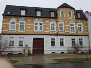 a large house with a brown and white at Ferienwohnung in Glindow