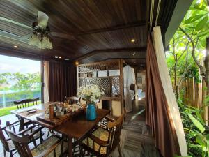 a dining room with a wooden table and chairs at Minh Boutique in Danang
