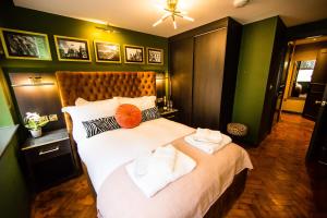 a bedroom with a large bed with two towels on it at LS1 - Luxury City Centre Apartments Leeds in Leeds