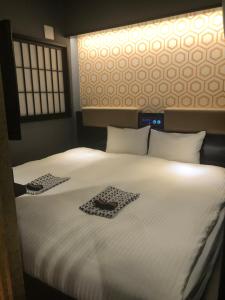 Letto o letti in una camera di cotoha Hotel Okachimachi