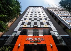 a tall building with an ac hotel sign on it at APA Hotel Ueno Hirokoji in Tokyo +50 photos