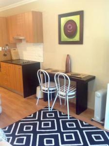 a kitchen with a table and chairs in a room at Brisbane Bayside Retreat in Birkdale