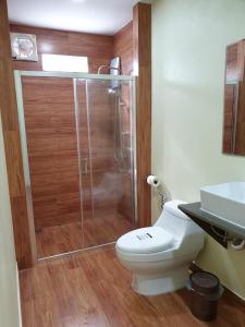a bathroom with a shower and a toilet and a sink at Na Cha Lae 1 ณ ชเล in Chanthaburi