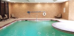 a swimming pool in a hotel room with a tub at Holiday Inn Hotel & Suites Lake Charles South, an IHG Hotel in Lake Charles