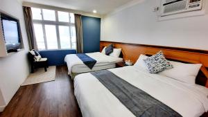 Postel nebo postele na pokoji v ubytování Kenting Chingshan Inn