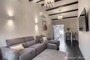 a living room with a couch and a table at Penthouse Leonarda with private parking in Pula