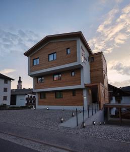a brown and white building on the side of a street at Alpe di Susi in Castelrotto