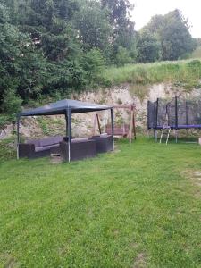 a gazebo sitting in a grass field at Na Zakręcie in Ochotnica Górna