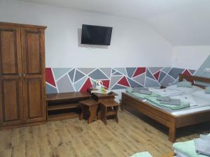a room with two beds and a tv on the wall at Air&Day in Vecsés