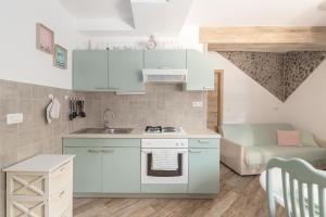 a small kitchen with a sink and a stove at Apartma Bohinj in Bohinj