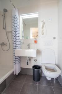een witte badkamer met een wastafel en een toilet bij Plaza 1 in Sveti Juraj