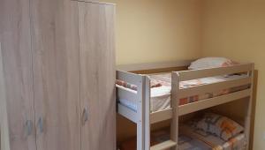 a small bedroom with a bunk bed and a cabinet at Apartment Sali in Kotor