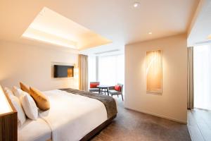 Postel nebo postele na pokoji v ubytování karaksa hotel premier Tokyo Ginza