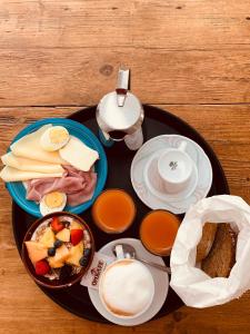 a table with a tray of breakfast foods and a tea pot at Hotel Villa Rina in Riva del Garda